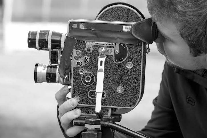 Student with film camera in black and white