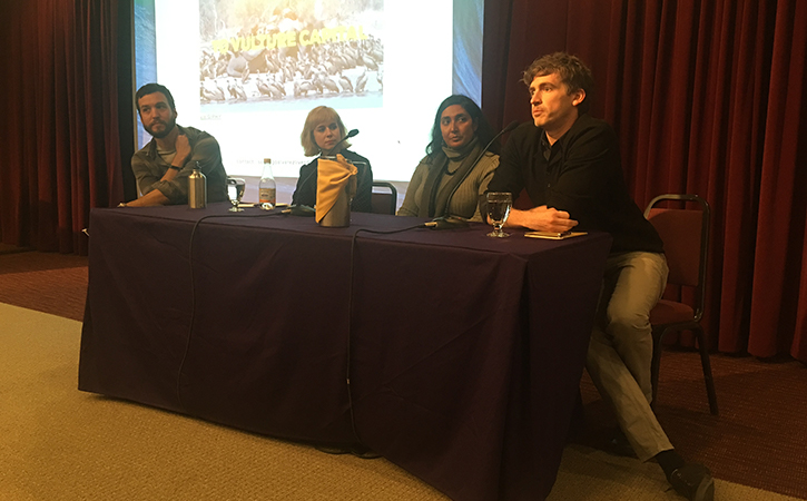 Four panelists sitting and speaking at the conference