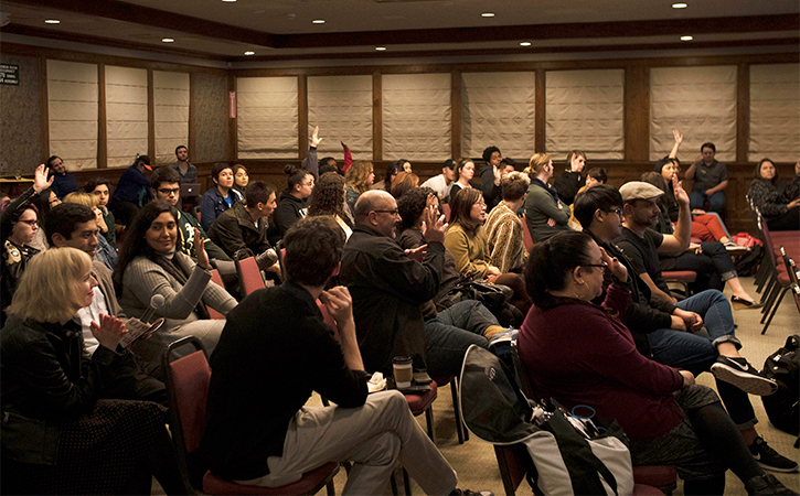 audience/crowd in a room to watch a screening